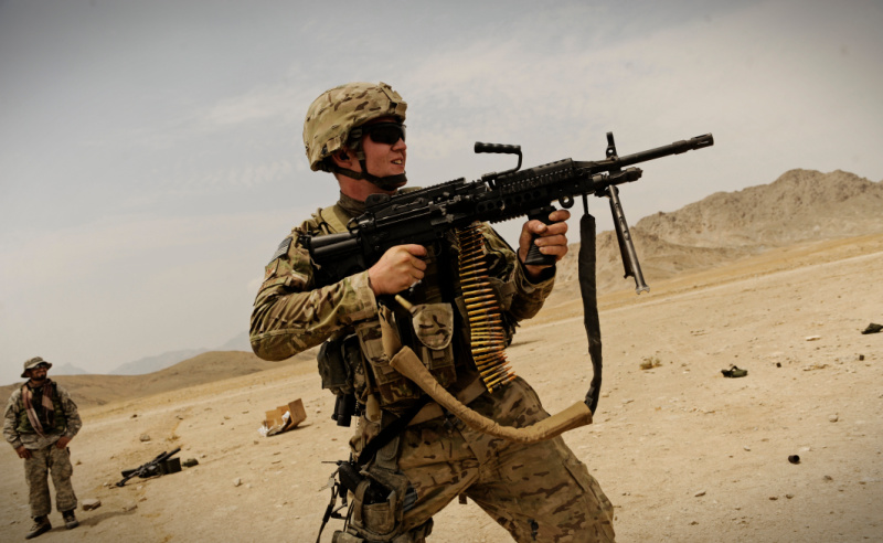 U.S. Air Force Staff Sgt. Timothy Husketh, a vehicle maintainer attached to the Laghman Provincial Reconstruction Team, fires his Mk-48 machine gun at wooden targets while practicing at an off-base firing range