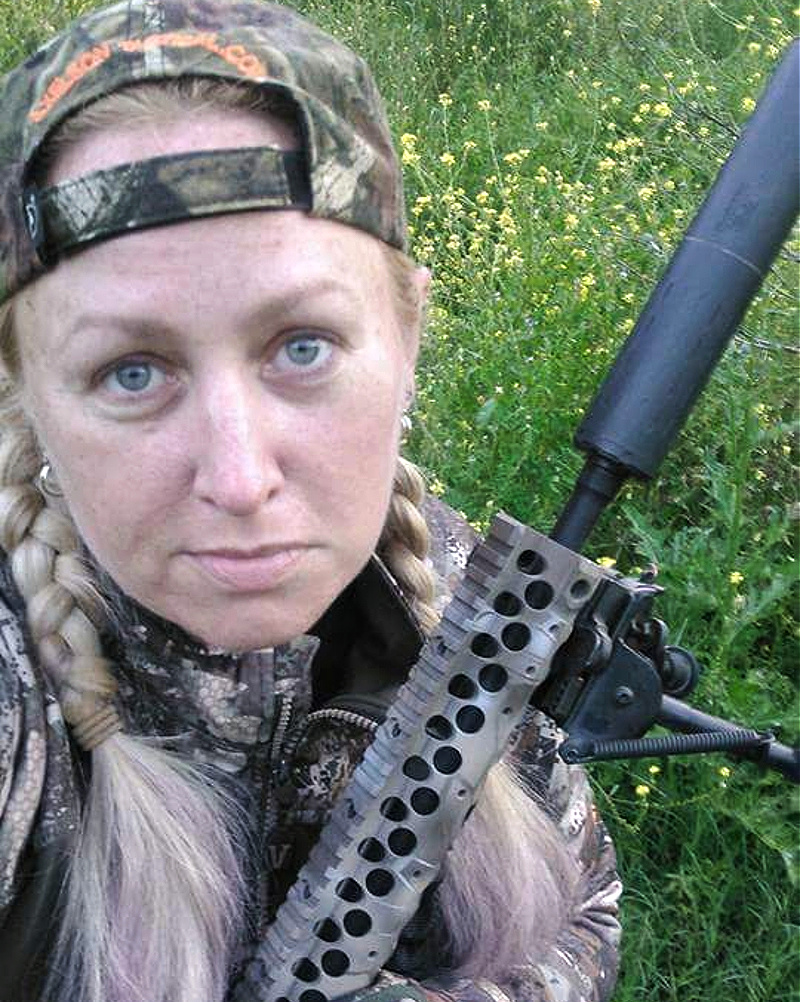 Kat Stevens holding rifle with SilencerCo Omega 300 - hunting with suppressors