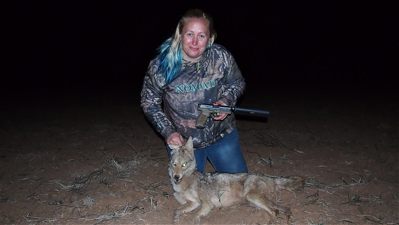 Kat Stevens with coyote hunted with handgun that is suppressed with SilencerCo Octane 9 - hunting with suppressors
