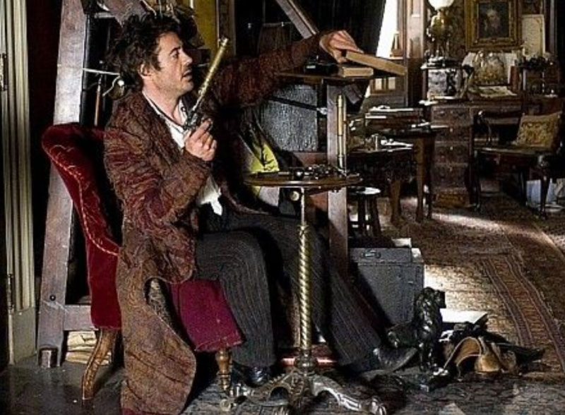 Robert Downey Jr. as Sherlock Holmes with silencer.