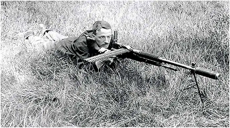 Maxim demonstrates his Maxim Silencer on an M-1909 light machine gun. (Public Domain)
