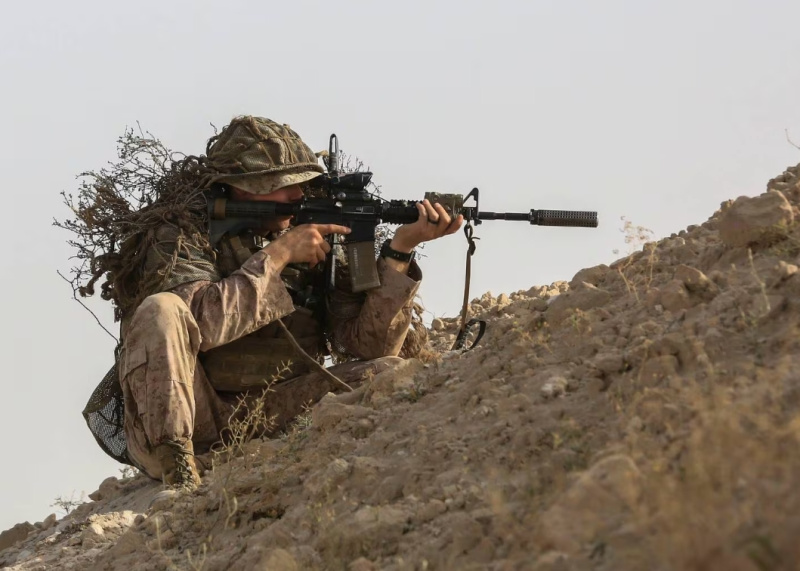 military suppressors -A US Marine fires a suppressed M-4 Carbine. (LCpl Kyle McNan/US Marine Corps)