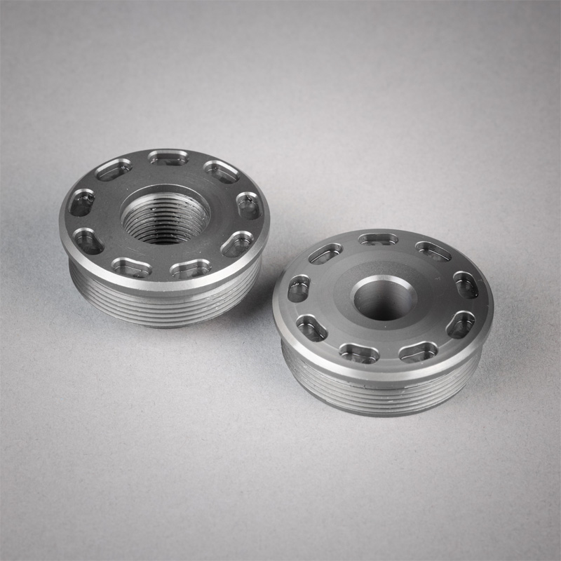 bravo titanium front cap and bravo titanium direct thread mount on a grey background