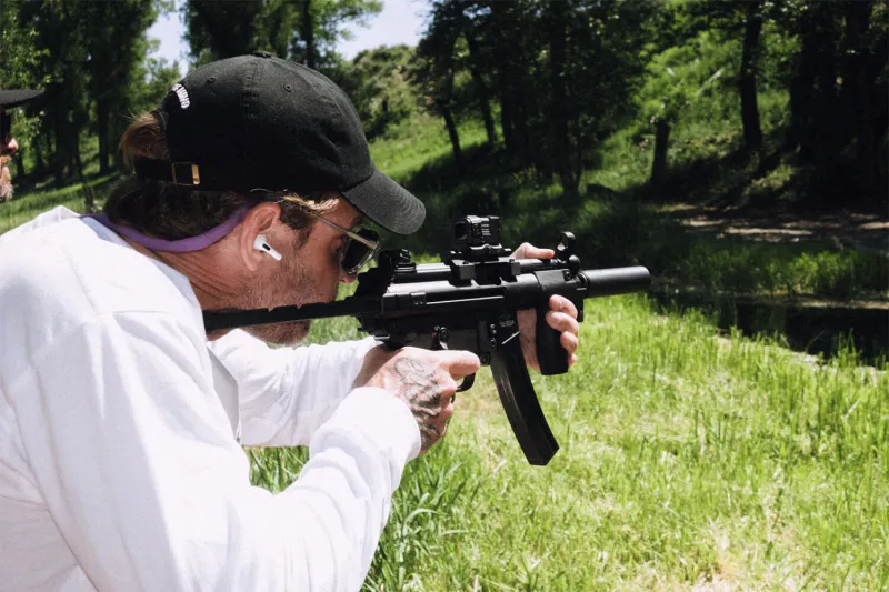 Man shooting subgun suppressed with SilencerCo Omega 9k - best subgun suppressor