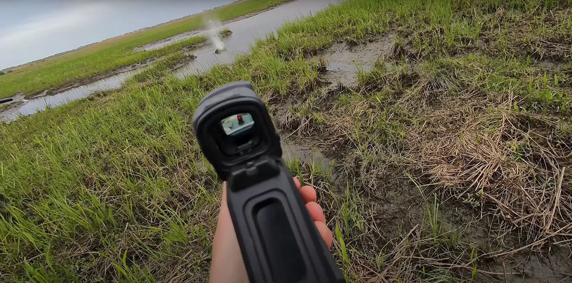 downrange view of nutria shot, optic visible as well as target impact.