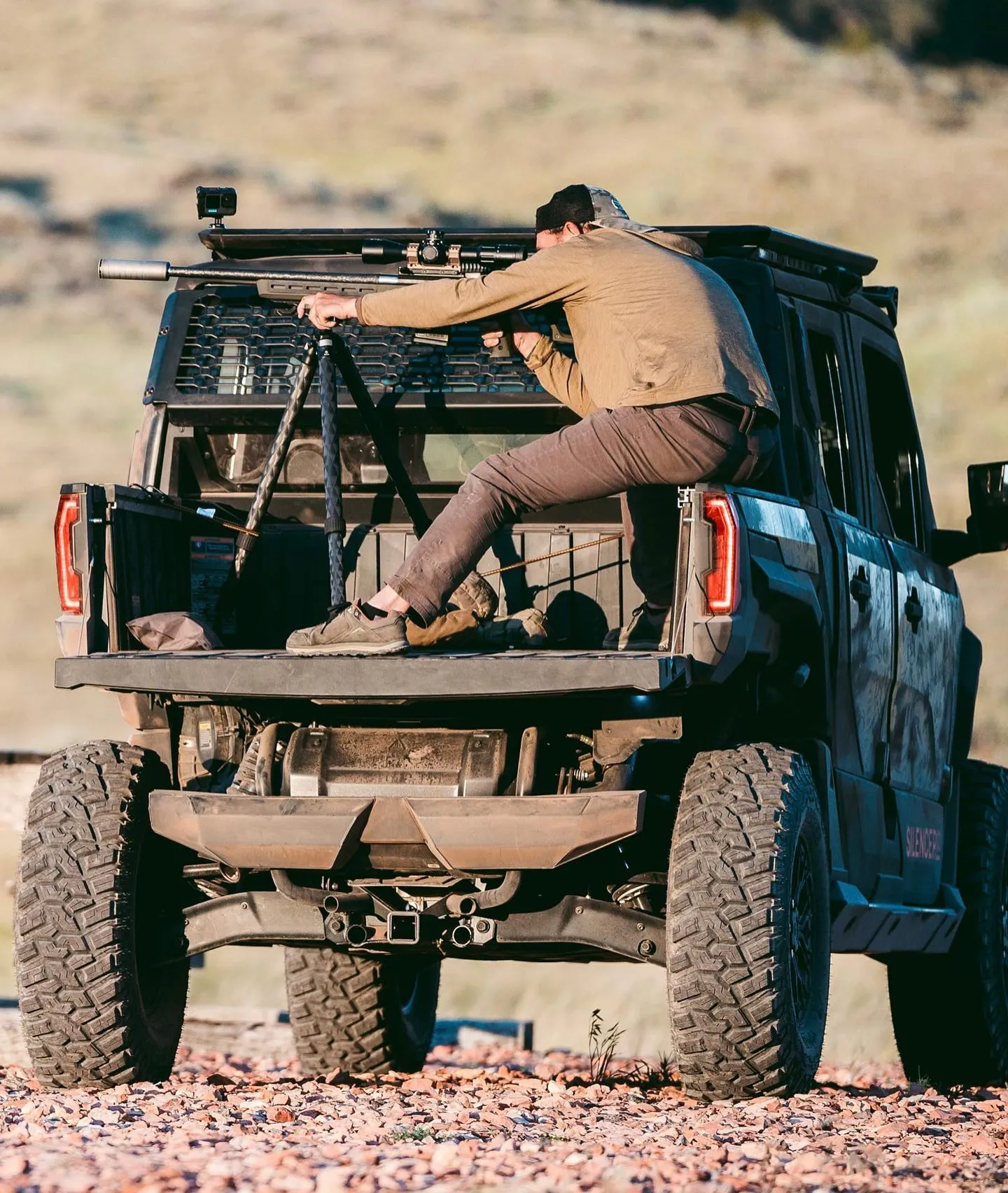 man shooting precision rifle with Scythe-Ti from back of the SilencerCo Polaris Defender.