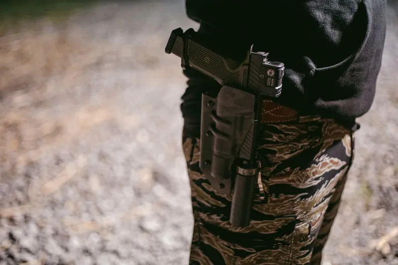 suppressed handgun, holstered