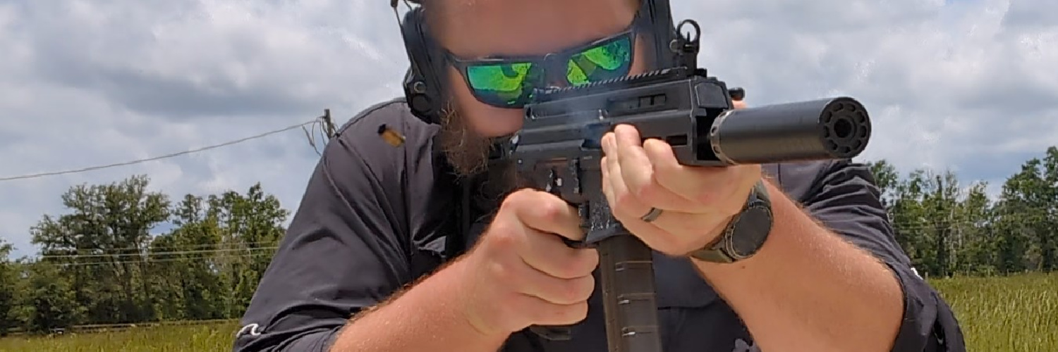 man shooting the Springfield Kuna, suppressed with SilencerCo Spectre 9