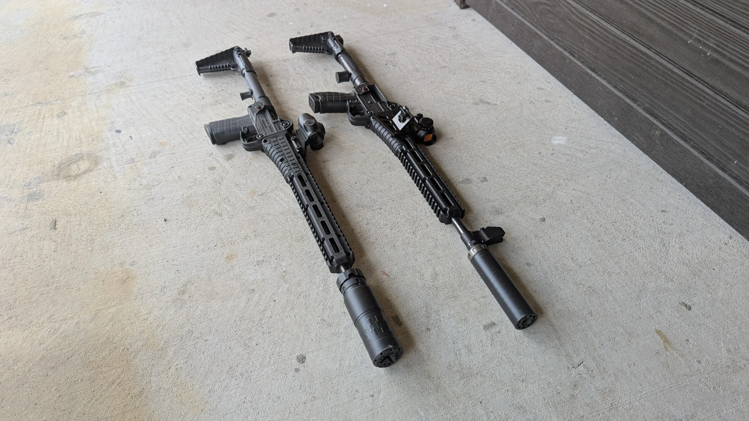 Two KelTec Sub 2000 rifles. One is a gen 2 9mm with a SilencerCo Spectre 9 suppressor. The other is a Gen 3 5.7mm with a Velos LBP 556k suppressor. Both are unfolded