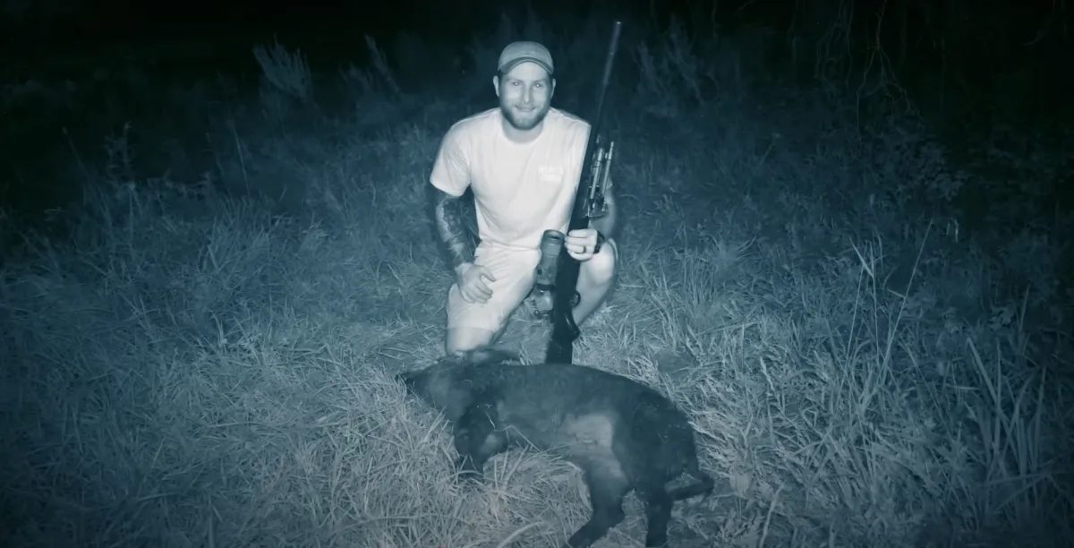 night vision view of a man with a hog he harvested with a .308 Remington 700, suppressed with a discontinued SilencerCo Saker 762 suppressor