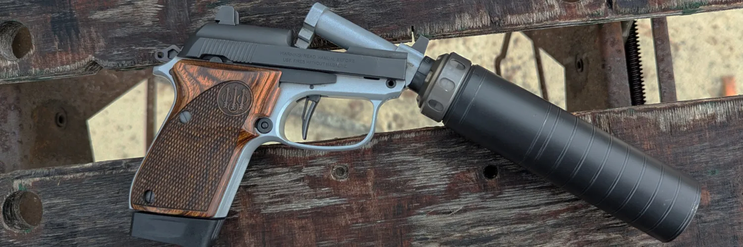 Beretta 30x Tomcat "Get Home Bag" handgun with barrel tilted up and SilencerCo Spectre 9 suppressor attached