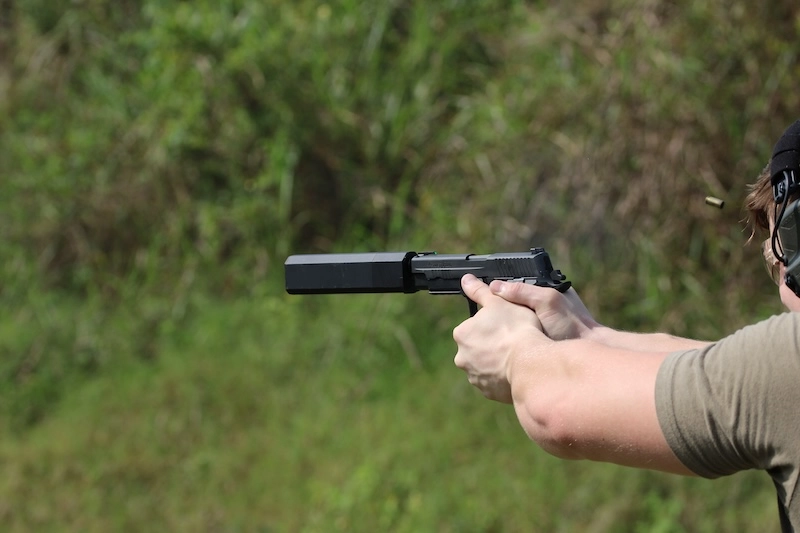 man shooting Sig P226 with Osprey 2.0 - suppressing a 9mm handgun