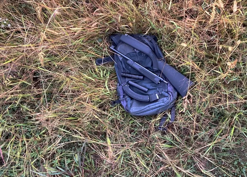 Ruger 10/22 Takedown, rimfire suppressors, BX-50 jungle mag, all on a backpack on the ground